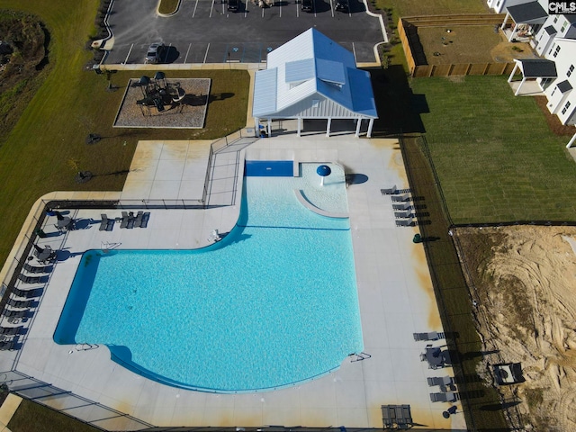 view of swimming pool with a yard and a patio area