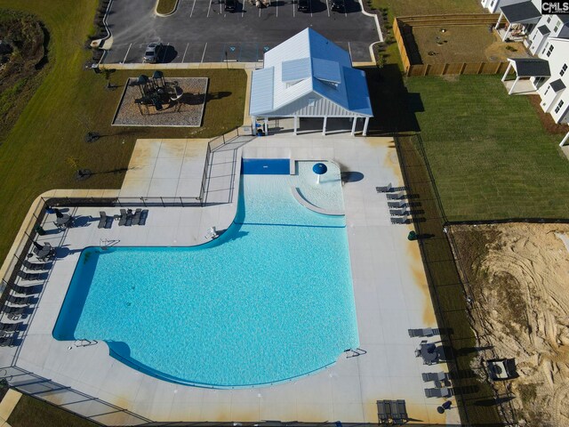 view of pool with a lawn and a patio