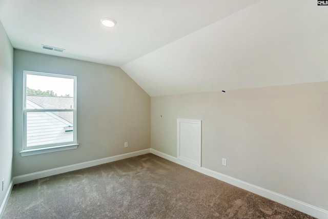 bonus room with lofted ceiling and carpet