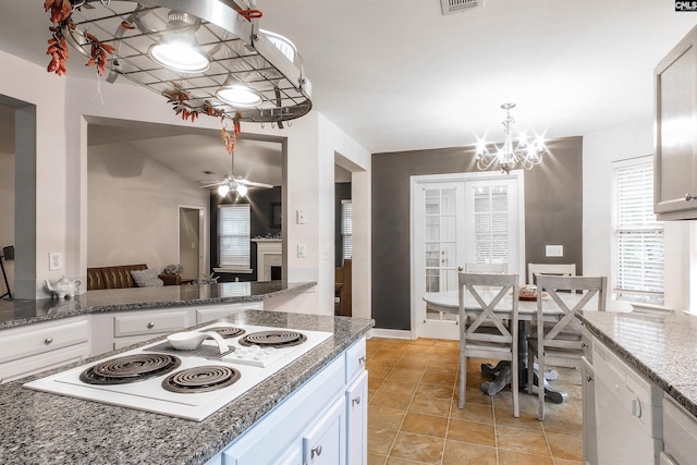 kitchen featuring vaulted ceiling, white cabinets, white appliances, ceiling fan, and decorative light fixtures