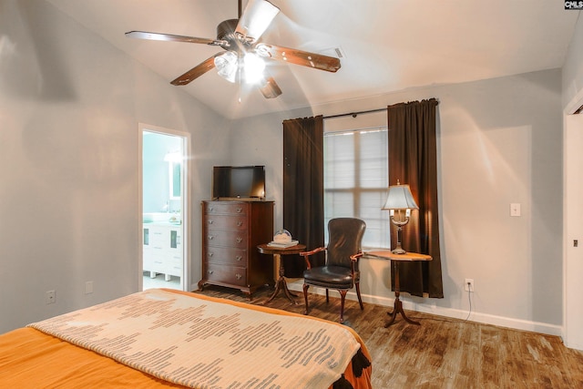 bedroom with connected bathroom, vaulted ceiling, ceiling fan, and hardwood / wood-style flooring