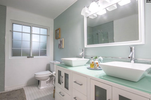 bathroom featuring a shower with shower door, vanity, crown molding, toilet, and tile patterned floors