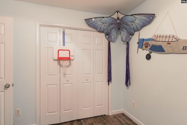 unfurnished bedroom featuring a closet and dark hardwood / wood-style flooring