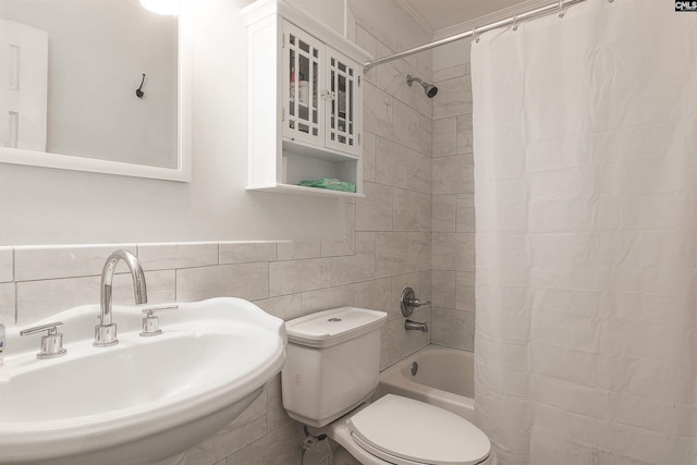 full bathroom with sink, tile walls, shower / tub combo, and toilet