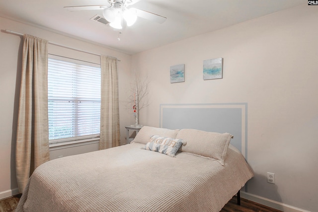 bedroom with ceiling fan and dark hardwood / wood-style flooring