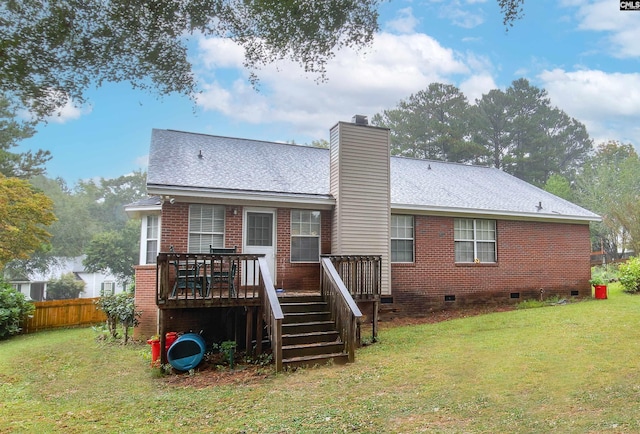 rear view of property with a wooden deck and a yard