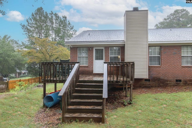 exterior space featuring a wooden deck and a yard