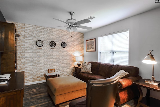 living room with ceiling fan, brick wall, and dark wood-type flooring