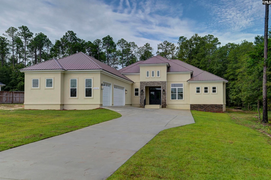 mediterranean / spanish house featuring a garage and a front yard