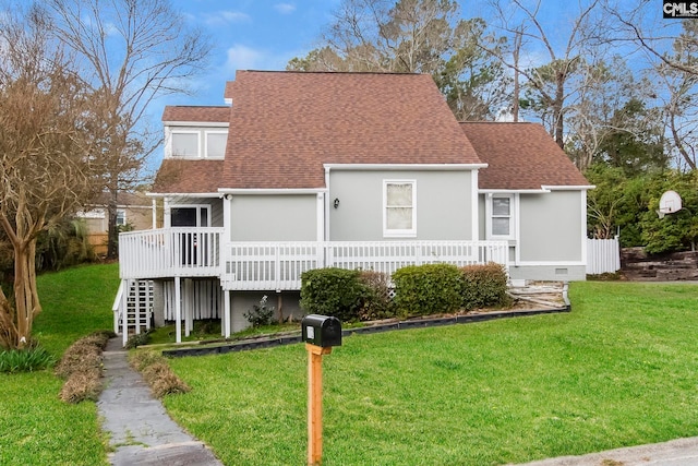 rear view of property featuring a yard