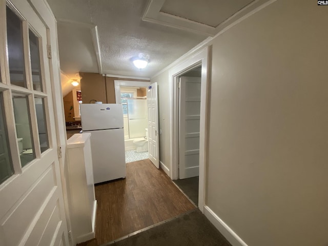 hall with baseboards, dark wood-style flooring, and a textured ceiling