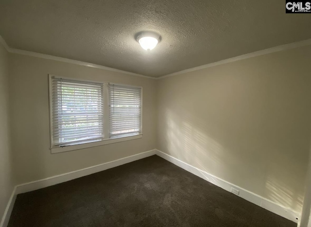 spare room with baseboards, a textured ceiling, dark carpet, and crown molding