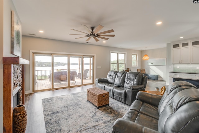 living room with ceiling fan, a wealth of natural light, and hardwood / wood-style flooring