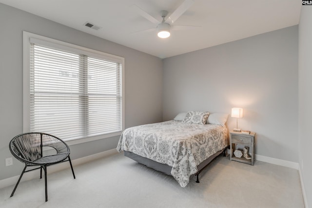 bedroom with ceiling fan and light carpet