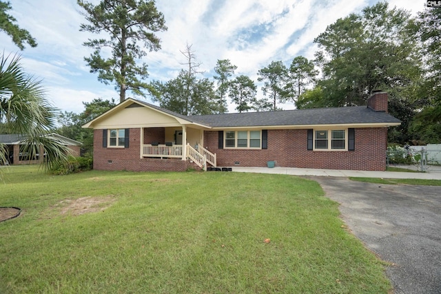 single story home with covered porch and a front lawn