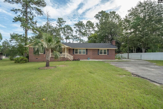 ranch-style home with a porch and a front yard