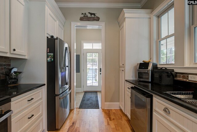 kitchen with light wood-type flooring, white cabinetry, plenty of natural light, and stainless steel appliances