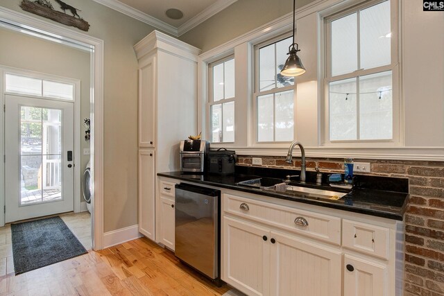 kitchen with pendant lighting, crown molding, light hardwood / wood-style flooring, dishwasher, and sink