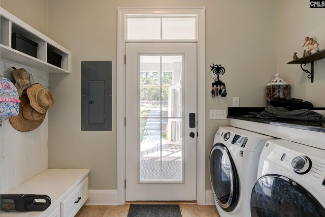 clothes washing area with electric panel and washing machine and dryer