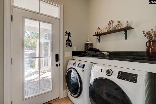 clothes washing area with washer and dryer