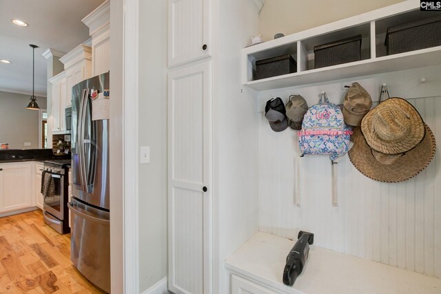 mudroom with light hardwood / wood-style flooring and ornamental molding