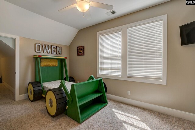 living area featuring carpet, ceiling fan, and vaulted ceiling