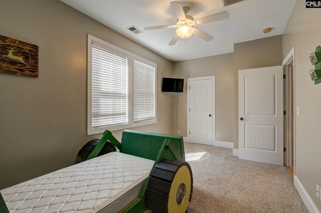 bedroom featuring ceiling fan and carpet