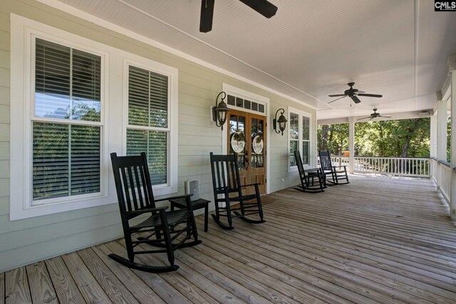 wooden deck featuring a porch and ceiling fan