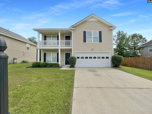 traditional-style home featuring a front yard, a balcony, fence, driveway, and an attached garage