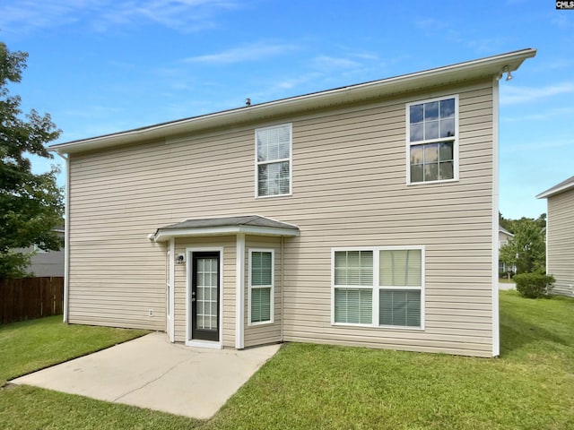 rear view of property with a yard, a patio area, and fence