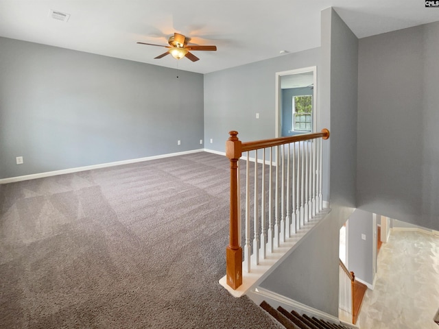 unfurnished room featuring ceiling fan and carpet