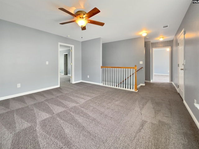 spare room featuring ceiling fan and carpet