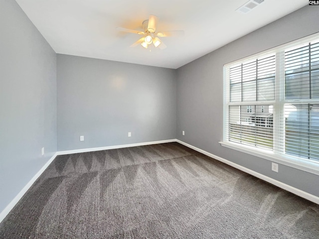 carpeted spare room featuring ceiling fan