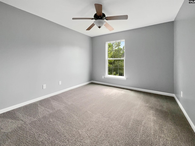 carpeted spare room featuring ceiling fan