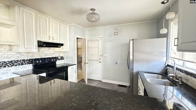 kitchen featuring black range with electric stovetop, decorative light fixtures, and dark stone counters