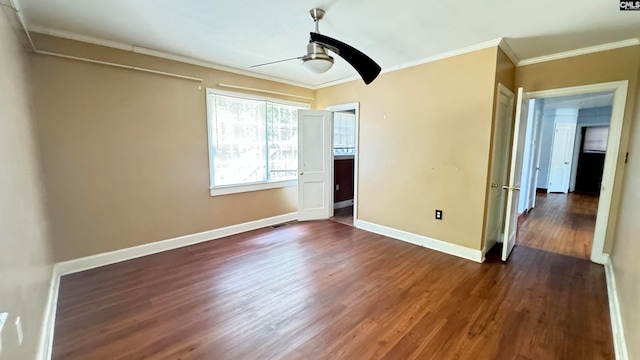 unfurnished room featuring crown molding, dark wood-type flooring, and ceiling fan