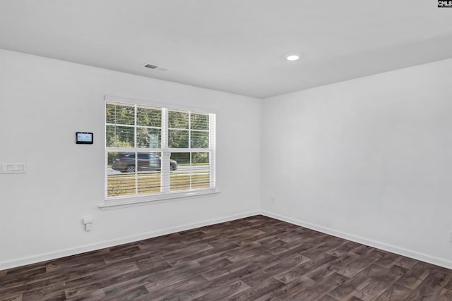 spare room with dark hardwood / wood-style flooring