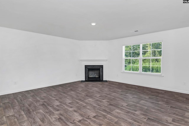 unfurnished living room featuring dark hardwood / wood-style flooring