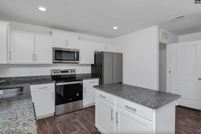 kitchen featuring appliances with stainless steel finishes, sink, white cabinets, and dark hardwood / wood-style floors