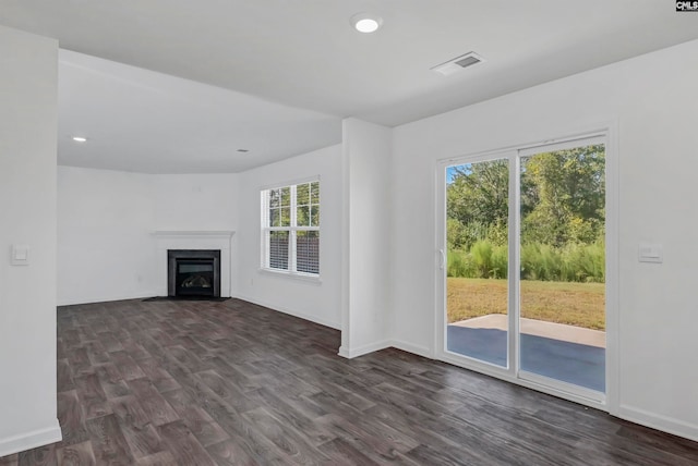 unfurnished living room featuring dark wood-type flooring