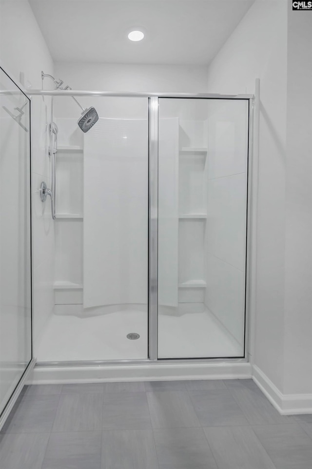 bathroom featuring tile patterned flooring and an enclosed shower