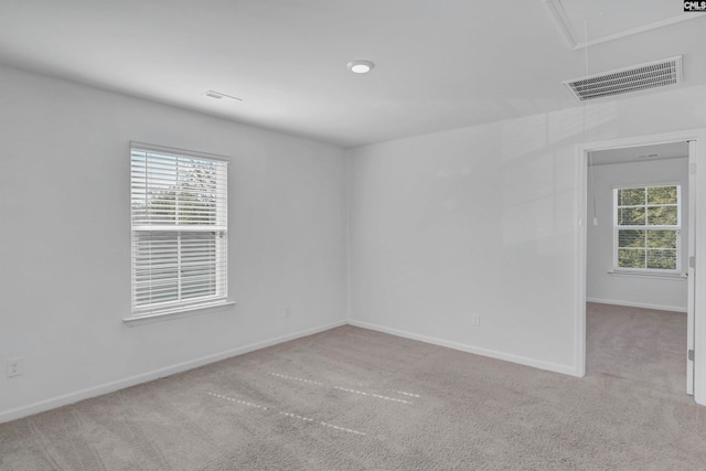 carpeted spare room with plenty of natural light