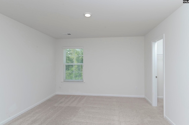 empty room featuring light carpet