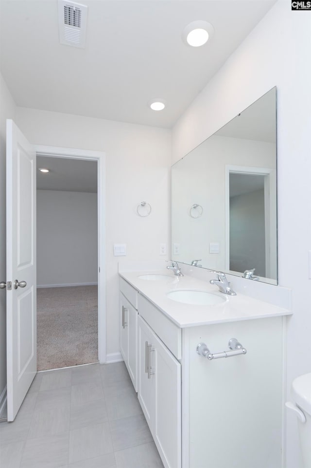 bathroom with vanity, toilet, and tile patterned floors