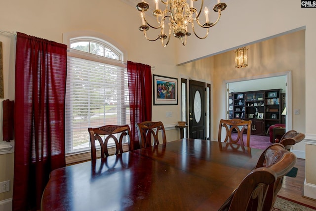 dining area with hardwood / wood-style flooring and a chandelier