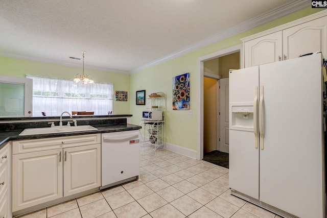 kitchen featuring light tile patterned floors, white appliances, sink, and a notable chandelier