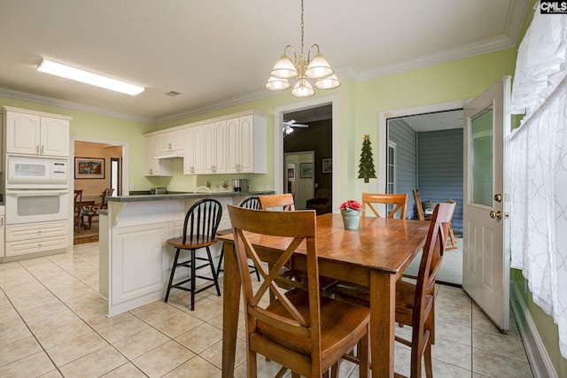 tiled dining area featuring ceiling fan with notable chandelier and ornamental molding