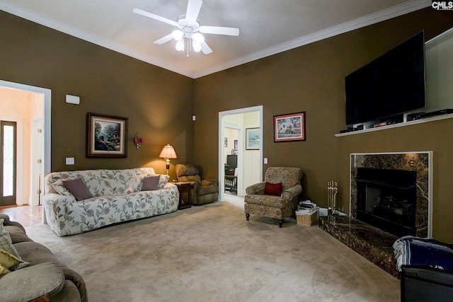 living room with light carpet, ceiling fan, crown molding, and a high end fireplace