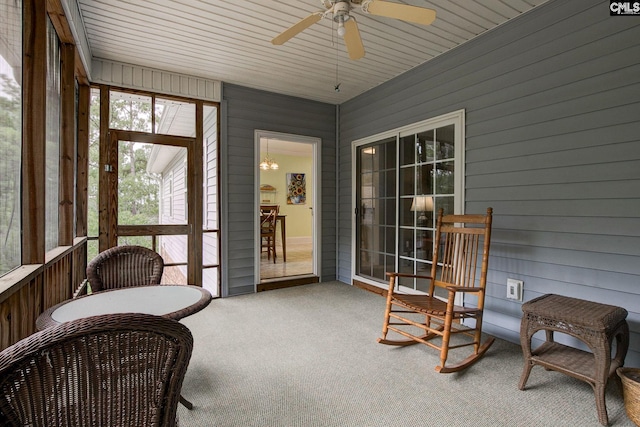 sunroom / solarium with wood ceiling and ceiling fan