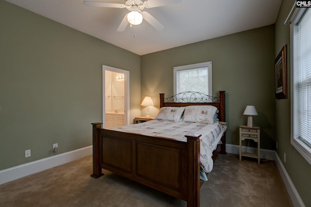 bedroom with carpet flooring, ceiling fan, and ensuite bathroom